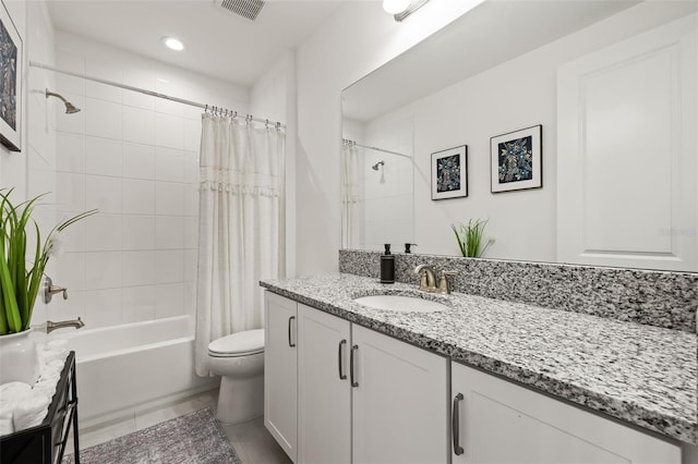 full bathroom with tile patterned floors, vanity, toilet, and shower / tub combo