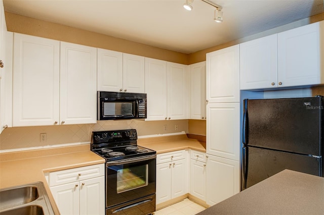 kitchen with decorative backsplash, white cabinets, light countertops, and black appliances