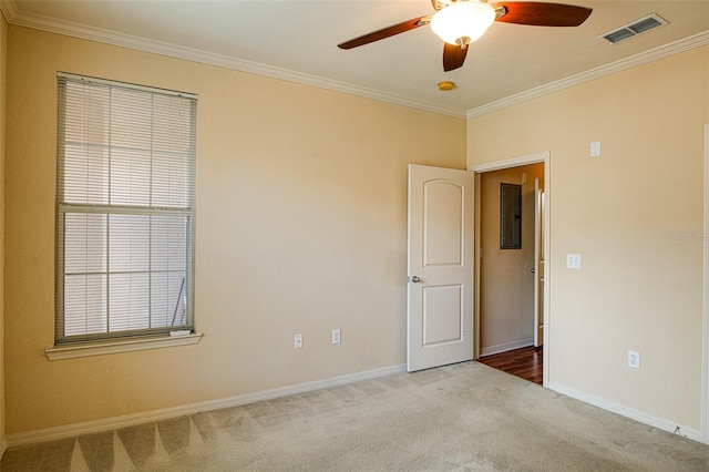 unfurnished room with electric panel, visible vents, ornamental molding, and light colored carpet