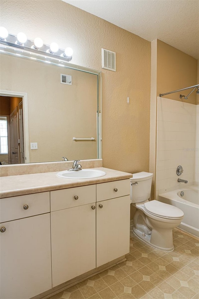 full bath with visible vents, vanity, toilet, and shower / bathtub combination