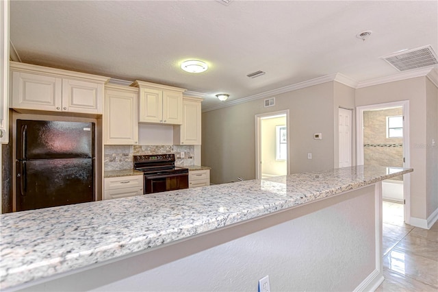 kitchen featuring light stone countertops, backsplash, crown molding, black appliances, and cream cabinetry