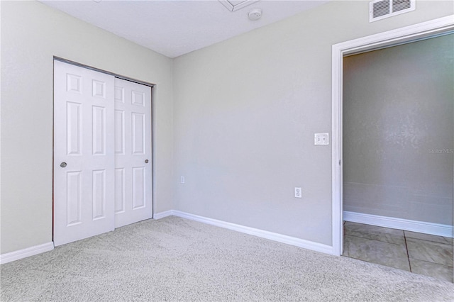 unfurnished bedroom with carpet flooring and a closet