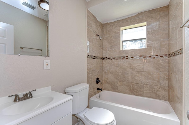 full bathroom with vanity, toilet, and tiled shower / bath