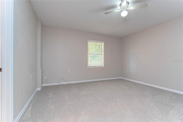 spare room featuring ceiling fan and carpet floors