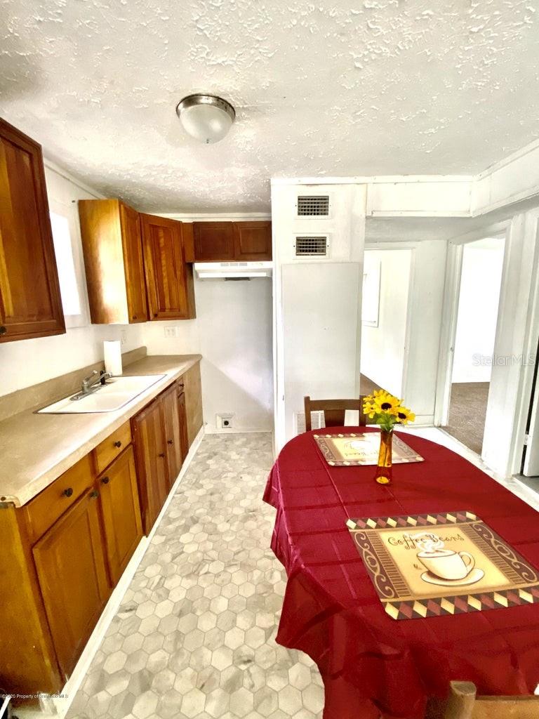 kitchen featuring a textured ceiling and sink