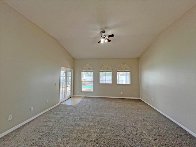 unfurnished room with ceiling fan, french doors, light colored carpet, and vaulted ceiling