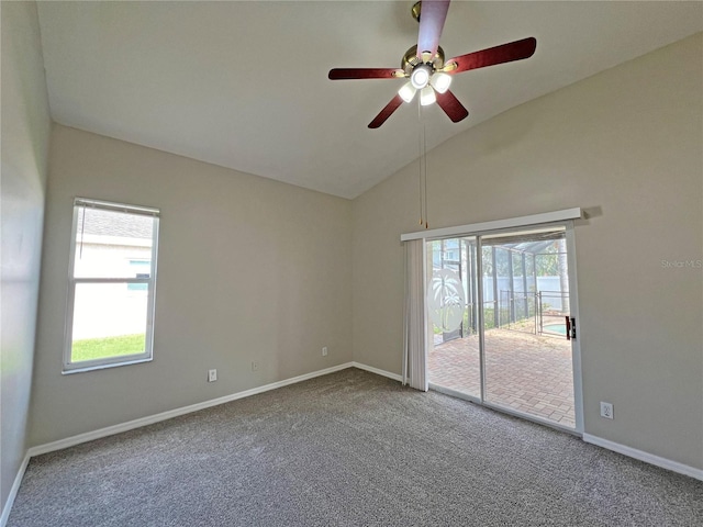 carpeted empty room featuring vaulted ceiling and ceiling fan