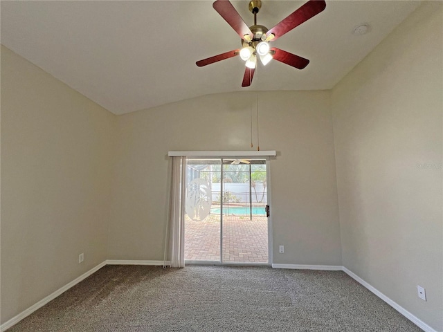 spare room featuring carpet floors, vaulted ceiling, and ceiling fan