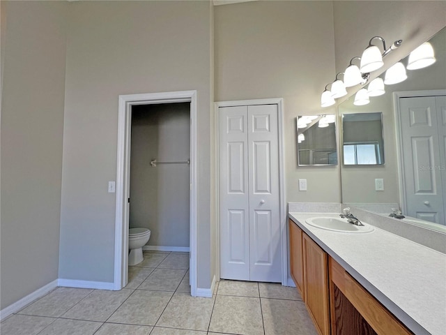 bathroom with tile patterned flooring, vanity, and toilet