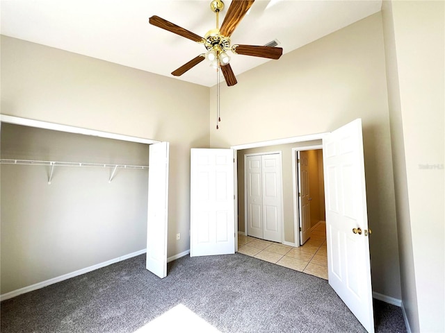 unfurnished bedroom with light carpet, ceiling fan, and lofted ceiling