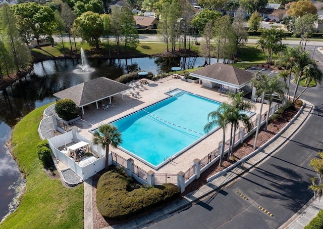 view of swimming pool with a water view and a patio