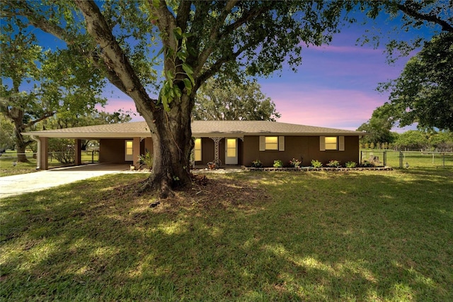 single story home with a carport and a lawn