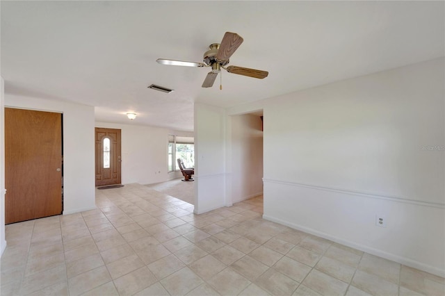 tiled spare room with ceiling fan