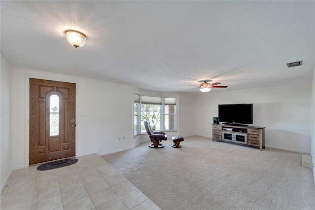 carpeted foyer entrance with ceiling fan and a textured ceiling