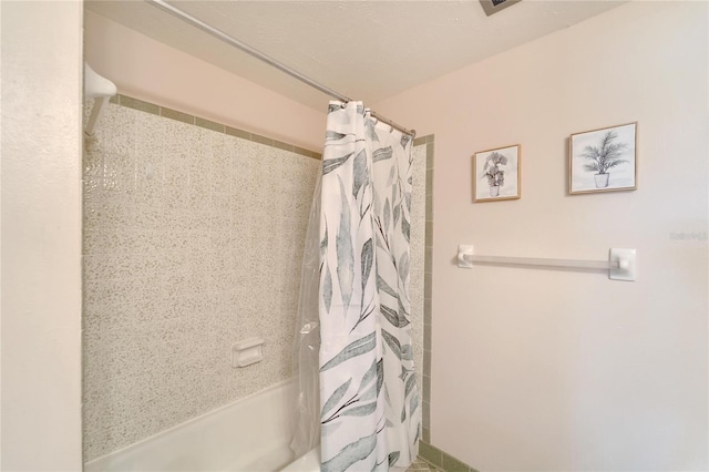 bathroom with shower / bath combination with curtain