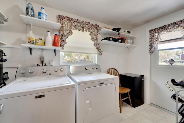 laundry area featuring plenty of natural light and separate washer and dryer