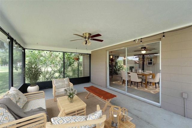 sunroom featuring ceiling fan