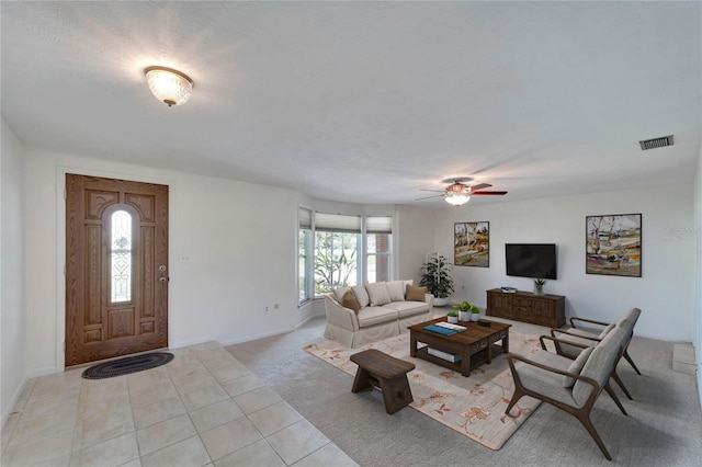 living room featuring light tile patterned flooring, a textured ceiling, and ceiling fan