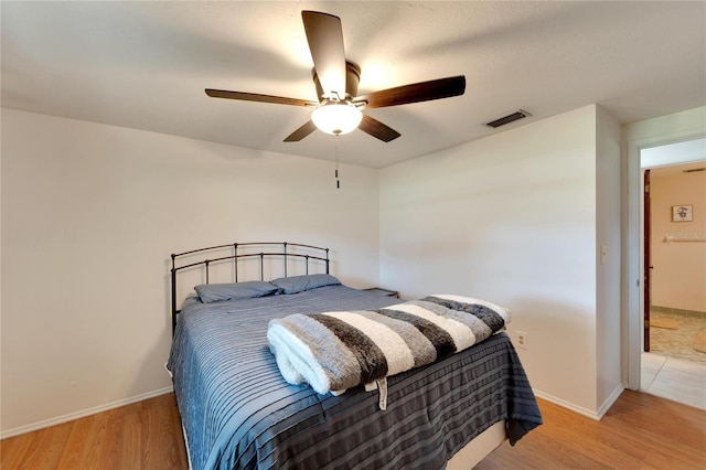 bedroom with light hardwood / wood-style flooring and ceiling fan