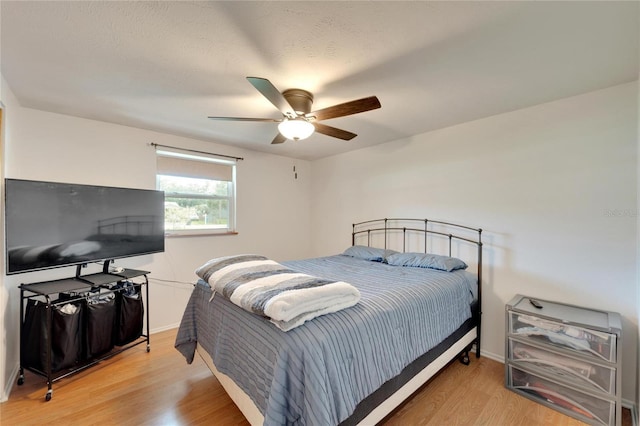 bedroom featuring wood-type flooring and ceiling fan