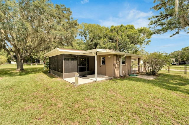 rear view of property with a yard and a patio area