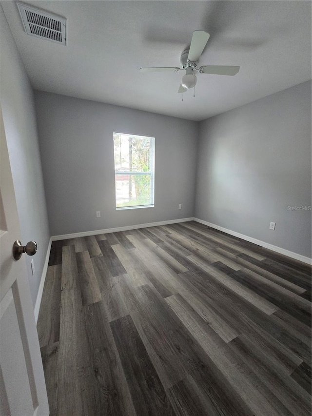 unfurnished room featuring ceiling fan and dark hardwood / wood-style flooring