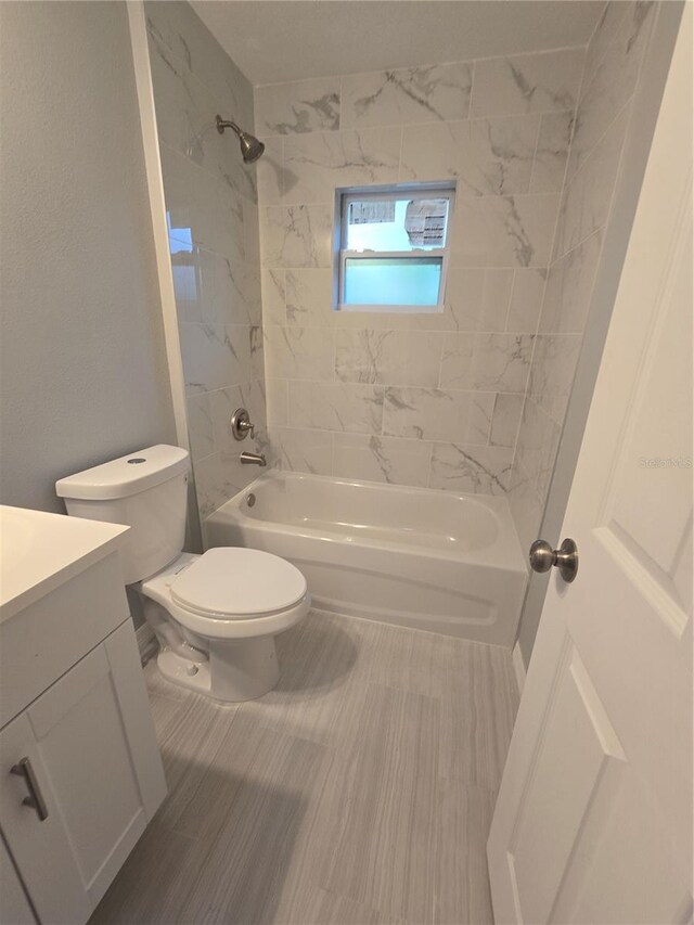 full bathroom with vanity, toilet, and tiled shower / bath combo