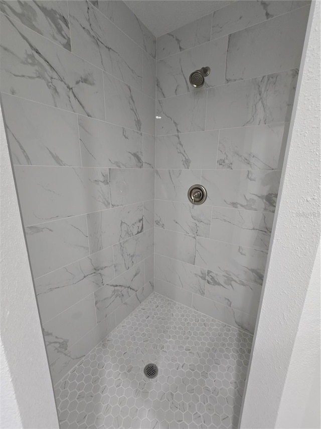 bathroom with a tile shower