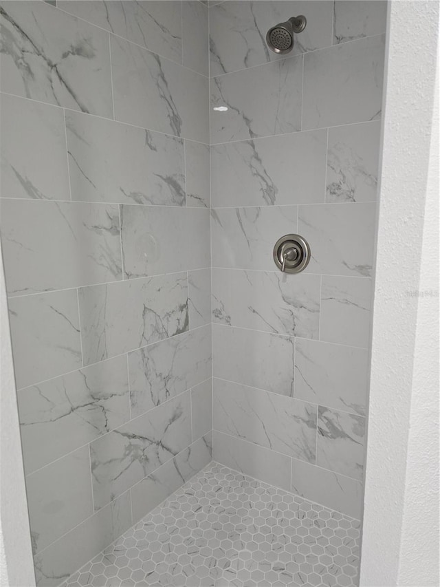 bathroom with tiled shower