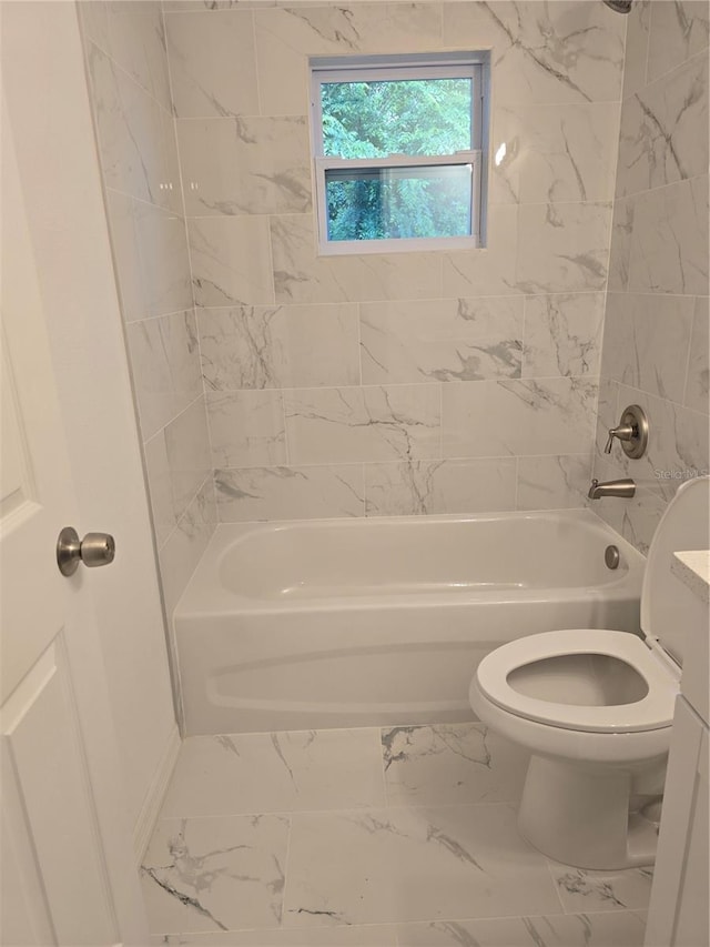 bathroom with marble finish floor, toilet, and shower / bathtub combination