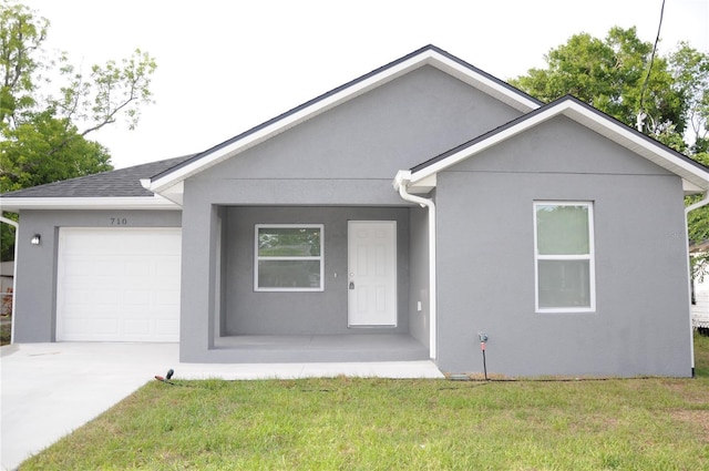 single story home with a garage, concrete driveway, a front lawn, and stucco siding