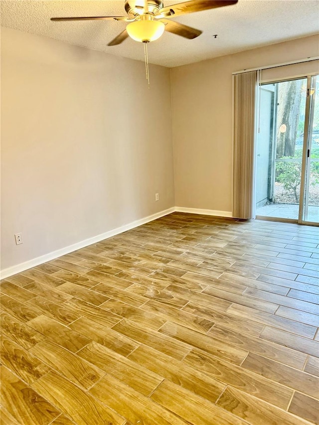 spare room featuring ceiling fan, hardwood / wood-style floors, and a textured ceiling