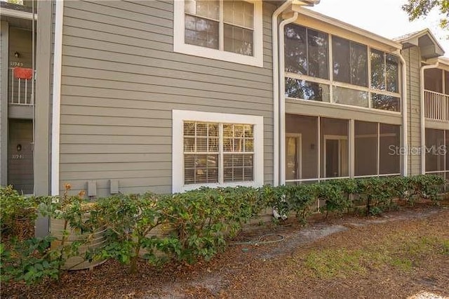 view of property exterior featuring a sunroom