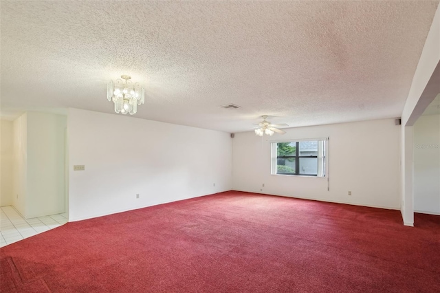 unfurnished room with ceiling fan with notable chandelier, a textured ceiling, and light colored carpet