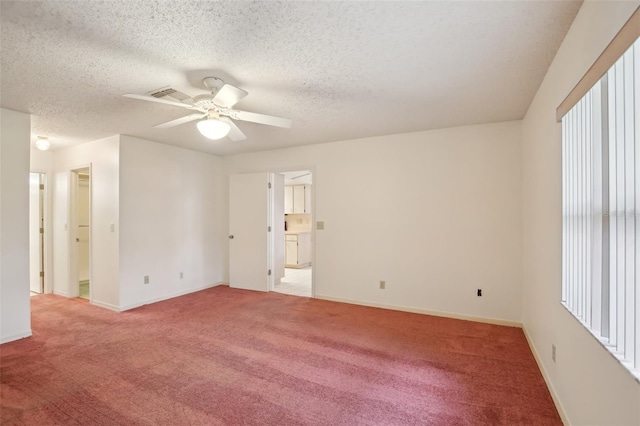 carpeted empty room featuring a textured ceiling and ceiling fan