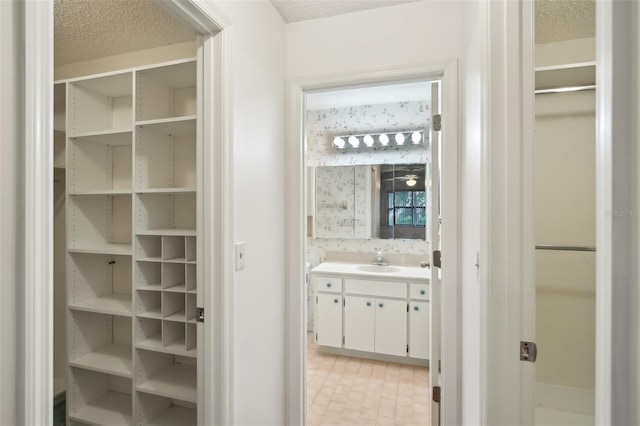 bathroom with vanity and a textured ceiling