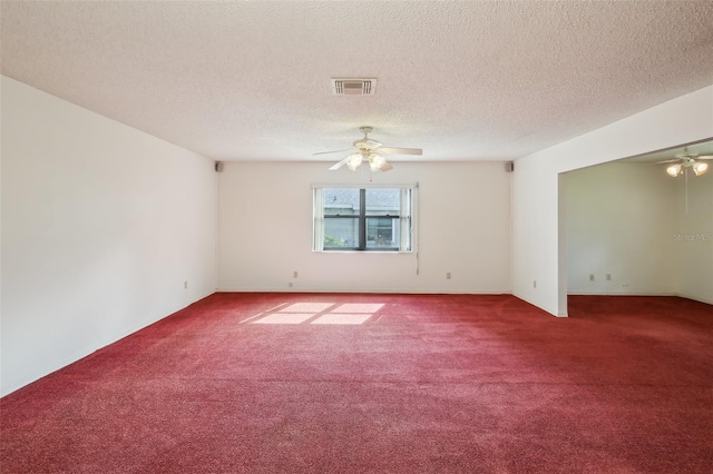 spare room featuring a textured ceiling, ceiling fan, and carpet