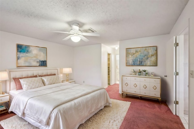 carpeted bedroom with a textured ceiling and ceiling fan