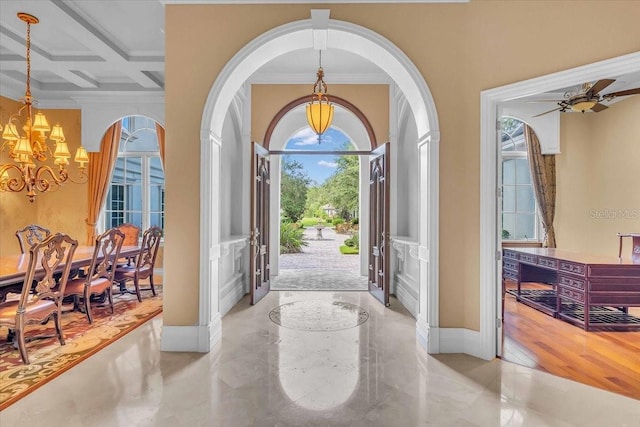 foyer with beamed ceiling, ceiling fan with notable chandelier, crown molding, and coffered ceiling