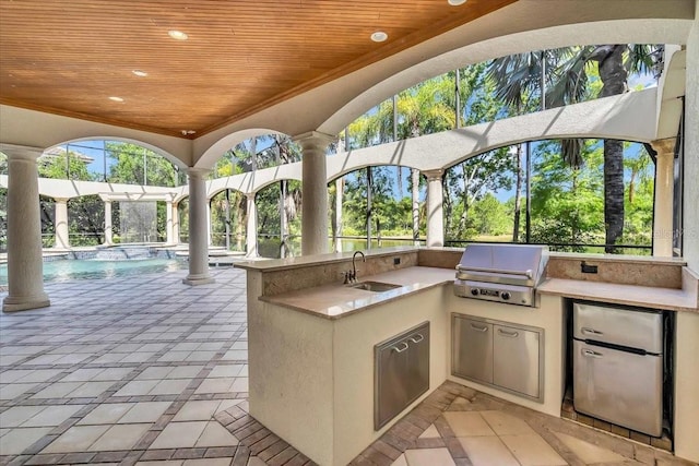 view of patio featuring exterior kitchen, sink, and grilling area