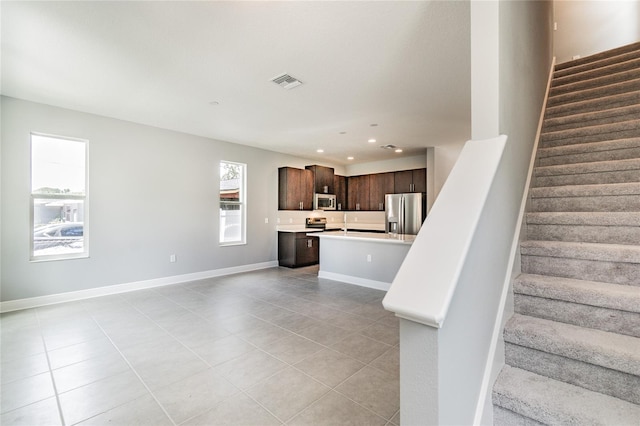 stairs featuring tile patterned flooring