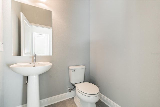 bathroom with tile patterned flooring and toilet