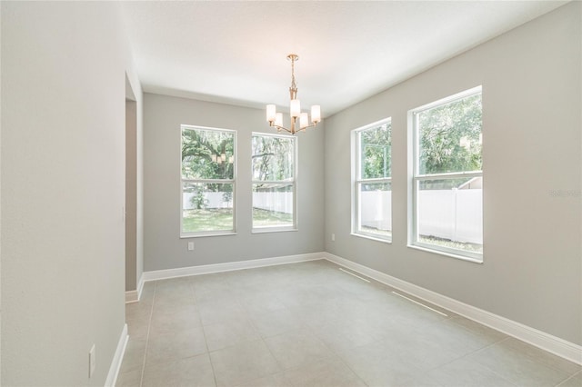 spare room with an inviting chandelier