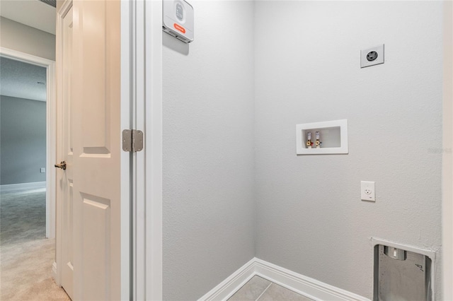 laundry area featuring electric dryer hookup, washer hookup, and light colored carpet