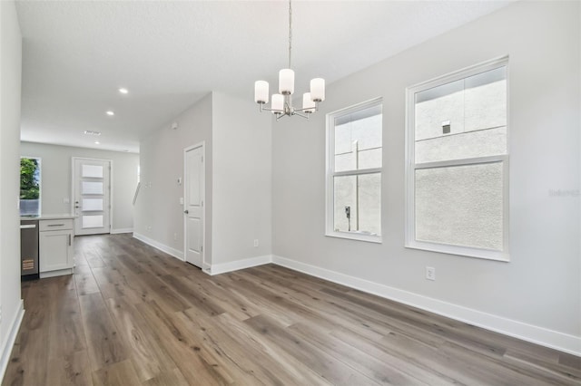 2909 W Spruce St, Tampa, FL 33607 - unfurnished dining area with a chandelier, wood finished floors, and recessed lighting