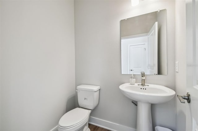 2909 W Spruce St, Tampa, FL 33607 - half bathroom featuring baseboards and wood finished floors
