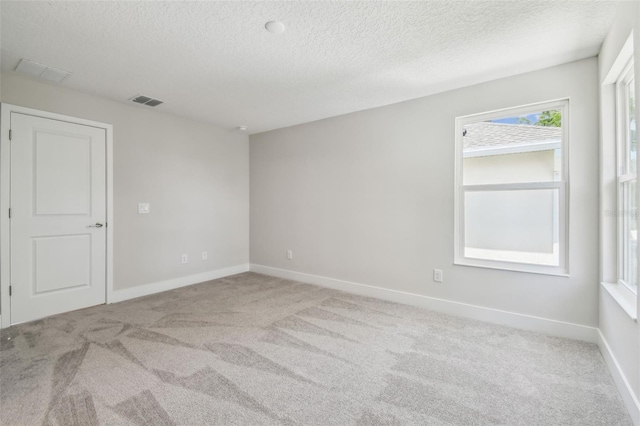 2909 W Spruce St, Tampa, FL 33607 - carpeted empty room with a textured ceiling and baseboards