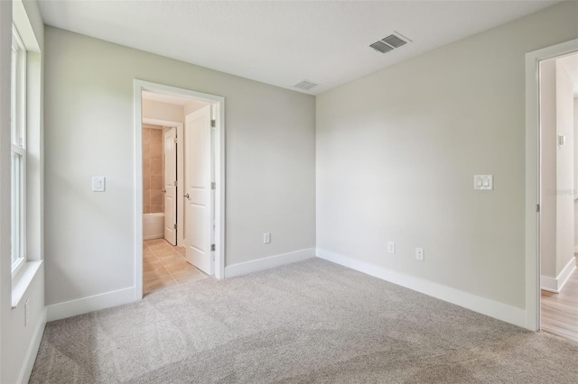 2909 W Spruce St, Tampa, FL 33607 - spare room featuring light carpet