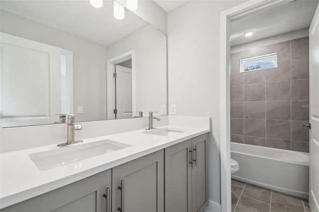 2909 W Spruce St, Tampa, FL 33607 - bathroom featuring double vanity, tile patterned floors, and shower / washtub combination