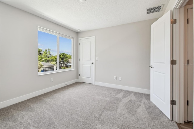 2909 W Spruce St, Tampa, FL 33607 - carpeted spare room with baseboards and a textured ceiling